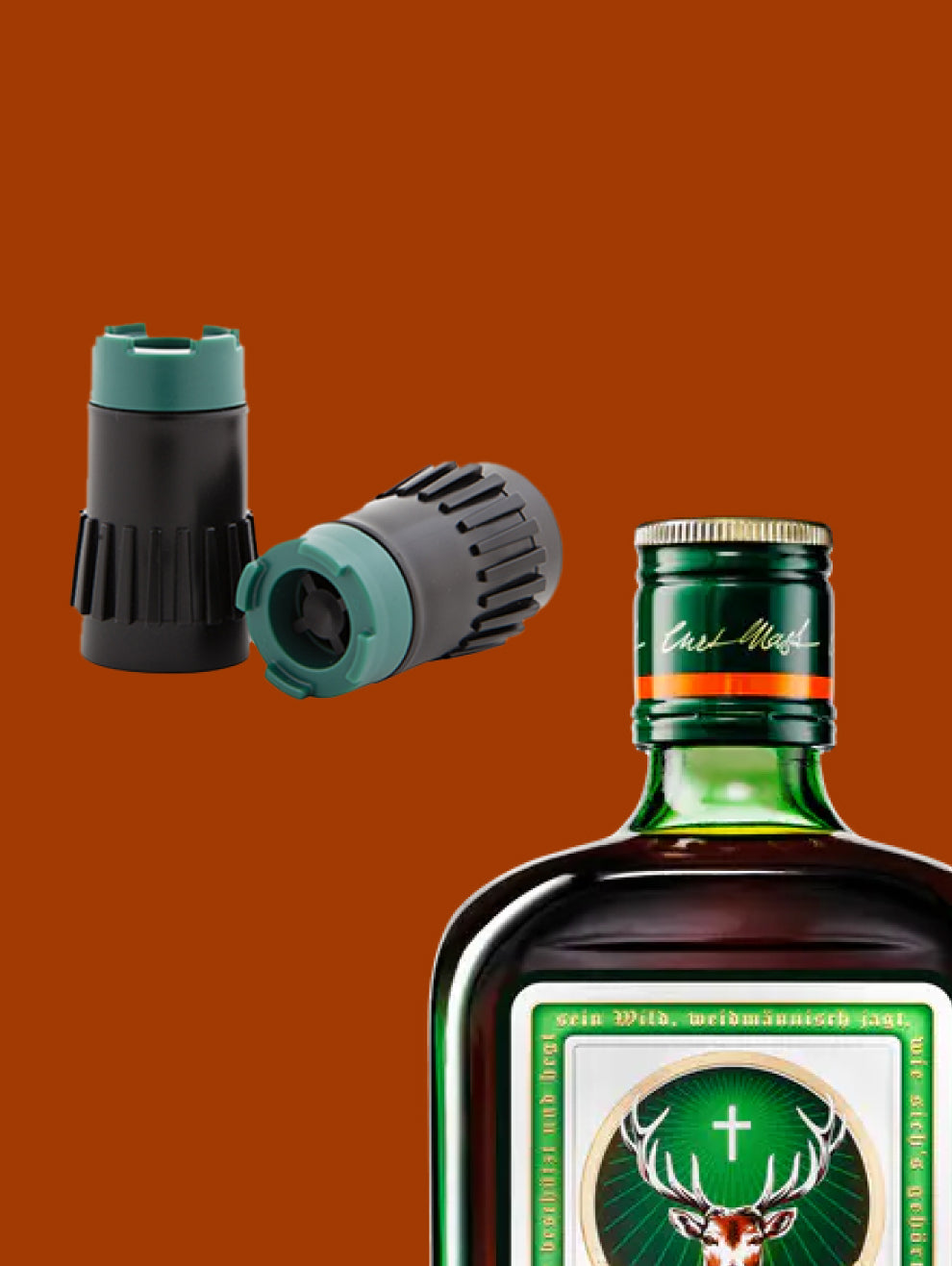 Two specialized bottle stoppers with green and black components are shown next to a Jägermeister bottle cap on a brown-orange background.